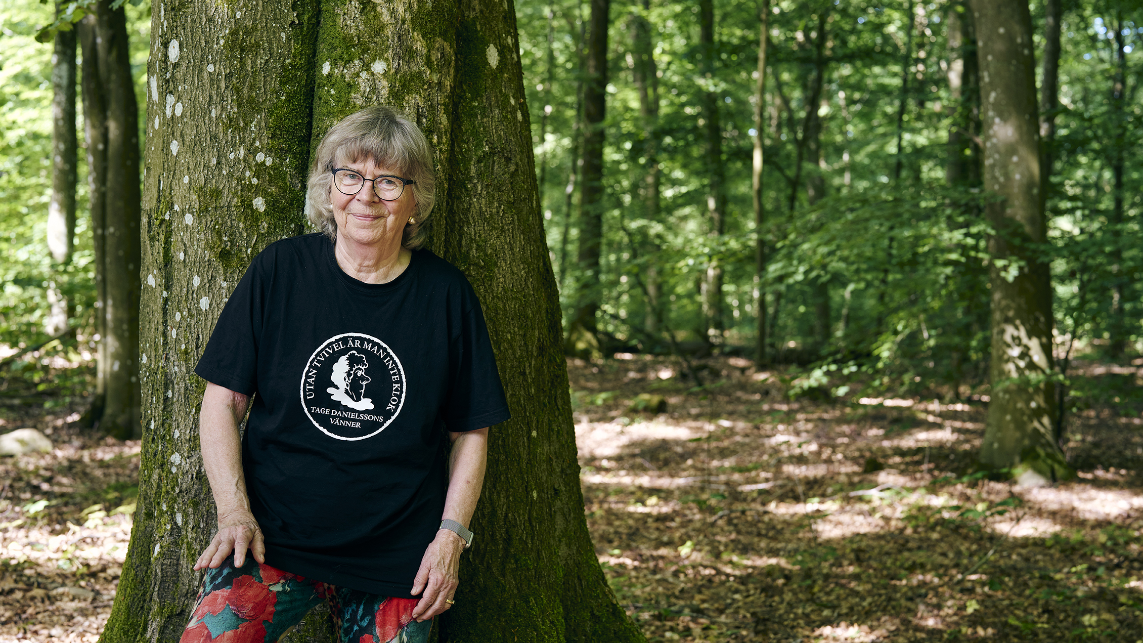 en kvinna står i en skog